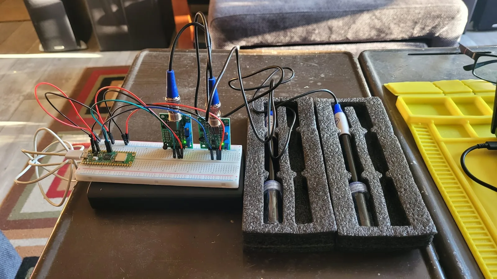 A Raspberry Pi Pico and two sensor boards on a breadboard, wired to pH and EC probes