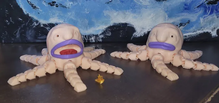 Two 3D-printed articulated octopuses on a desk