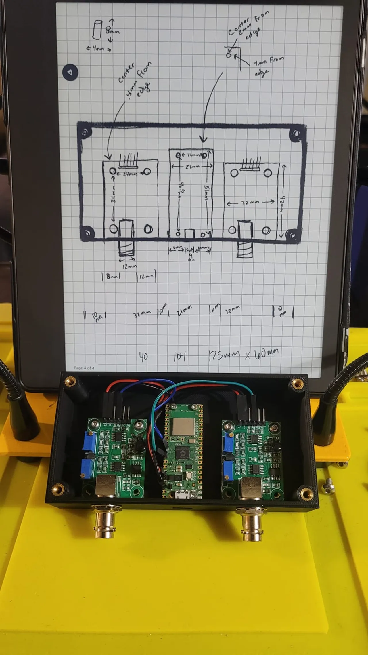 A 3D-printed enclosure holding a Raspberry Pi Pico and sensor boards, beside the hand-drawn design sketch