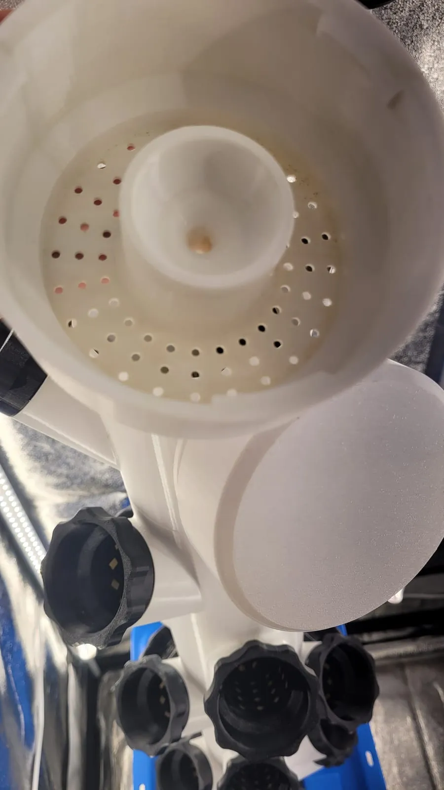 The printed inner cup and a row of black mesh pods with their threaded collars