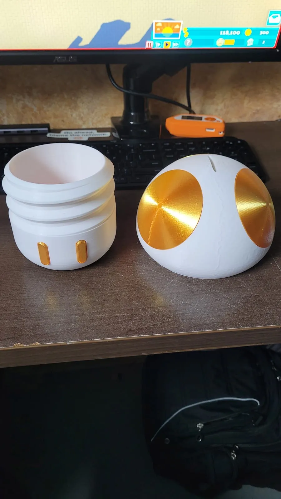 The same mushroom split into its two halves, the cap lifting off the base so coins drop inside